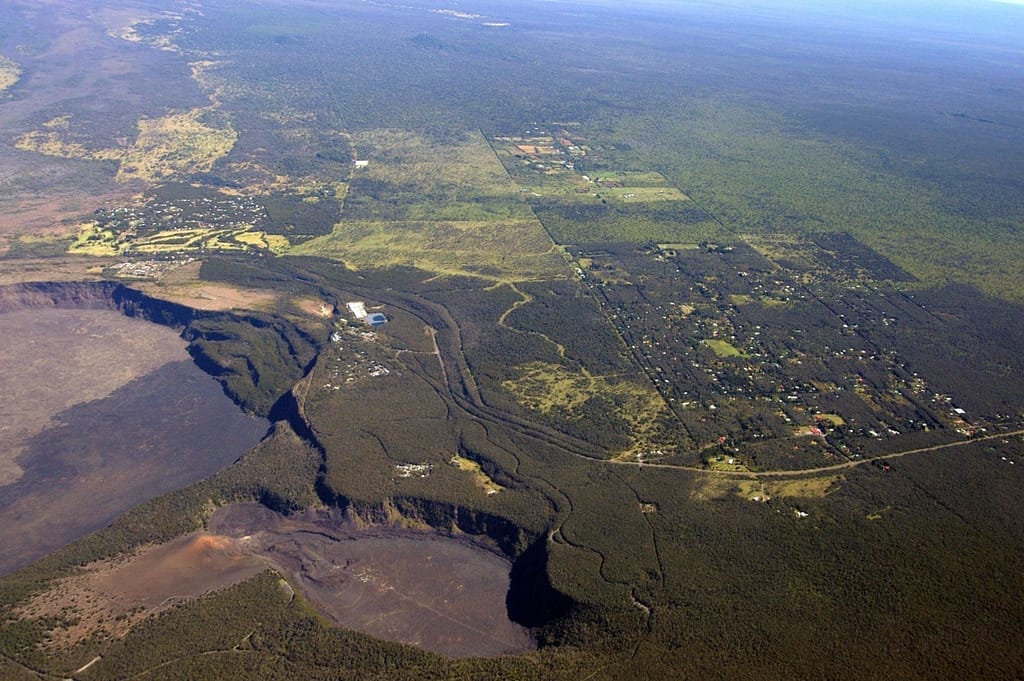 Volcano Aerial (L) Archive photo of woman golfing into Kilauea crater.