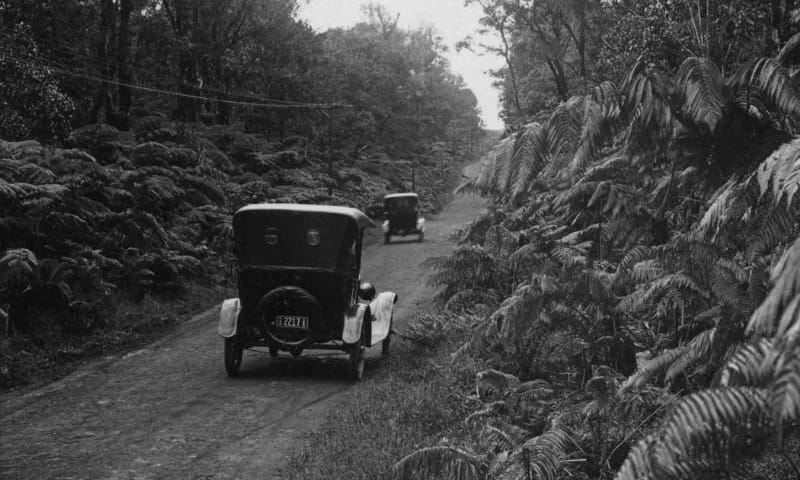 Car road (Card) Archival photo of old car driving through Volcano on dirt road.
